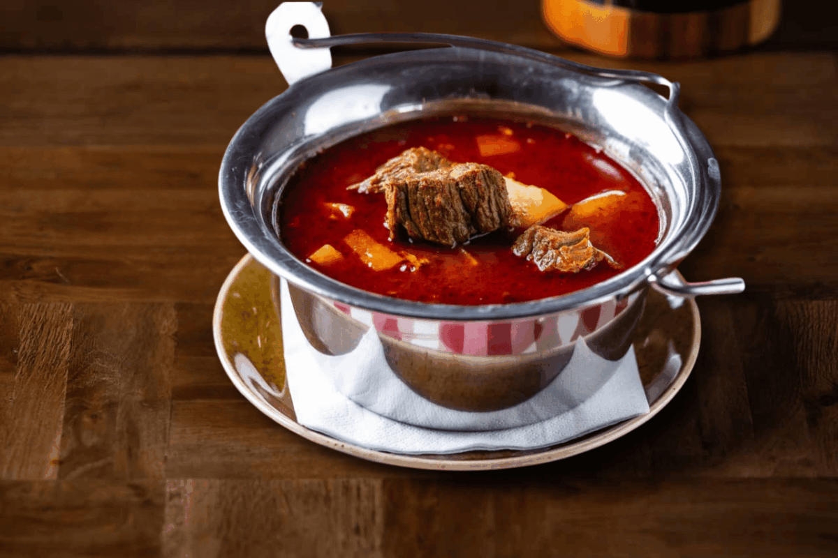 Goulash soup served in a traditional kettle – Arany Hordó Restaurant, Buda Castle